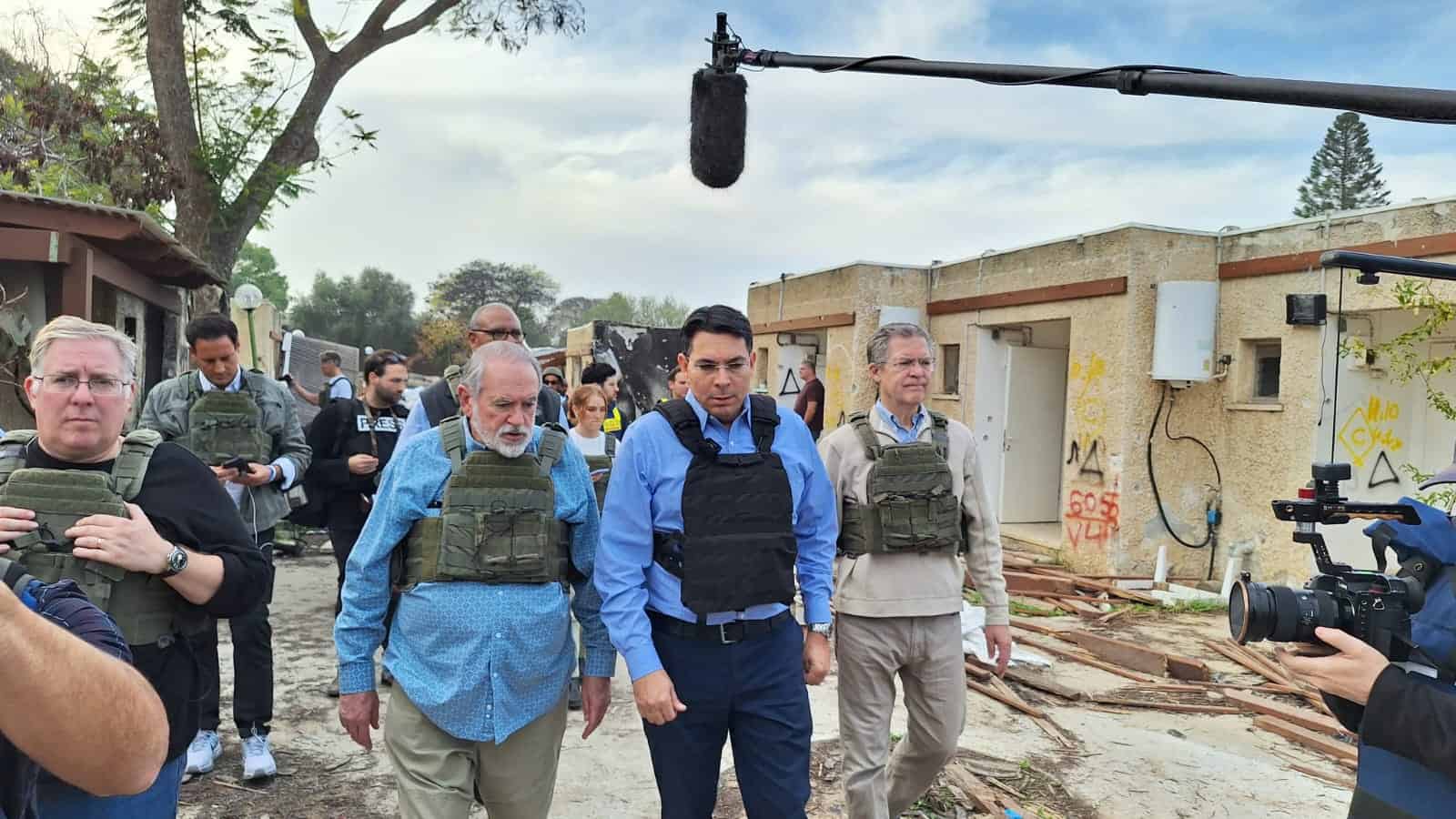 Former Arkansas Governor Mike Huckabee (left), MK Danny Danon (center) and former Kansas Governor Sam Brownback (right) at Kibbutz Kfar Aza, Dec. 20, 2023. Credit: Courtesy.