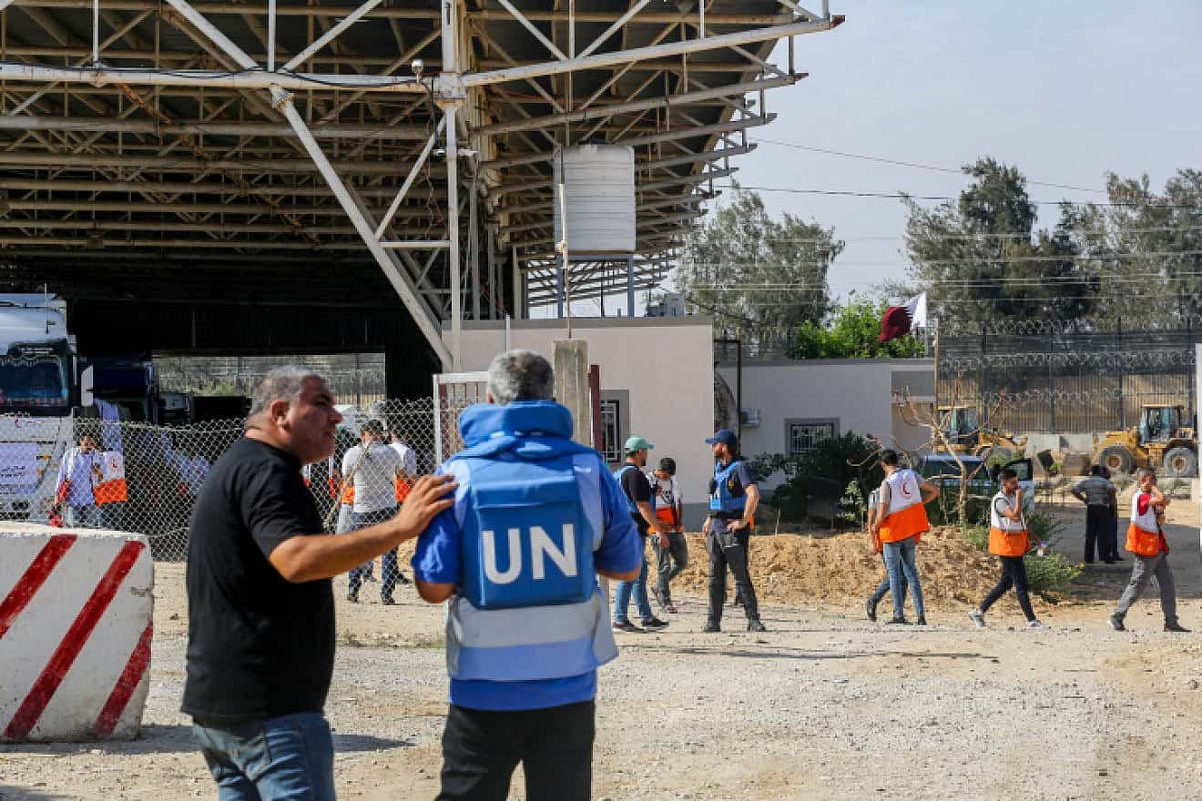 U.N. workers and empty trucks wait for the arrival of humanitarian aid at the Palestinian side of the Rafah border crossing with Egypt on Oct. 21, 2023. Photo by Atia Mohammed/Flash90.