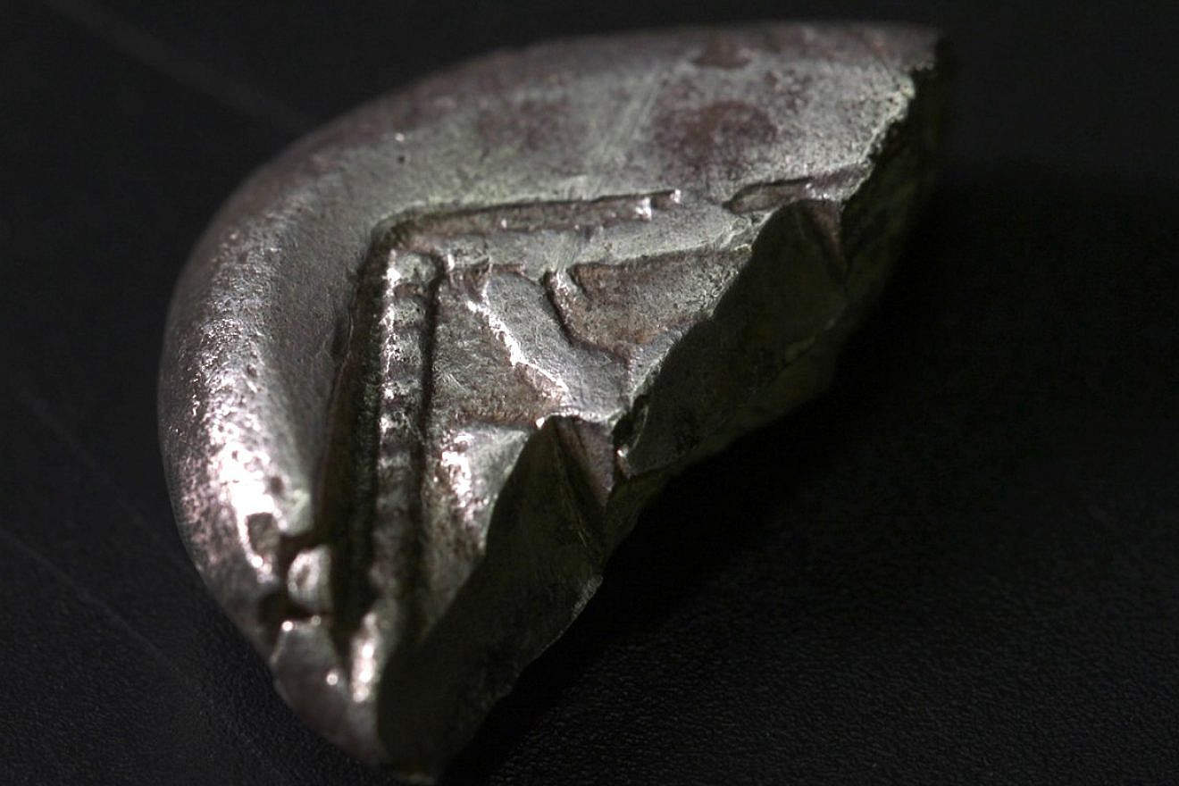 An extremely rare silver coin dated to the Persian period (6th-5th centuries BCE) is unearthed in the Judean Hills, Jan. 17, 2024. Photo by Emil Aladjem/Israel Antiquities Authority.