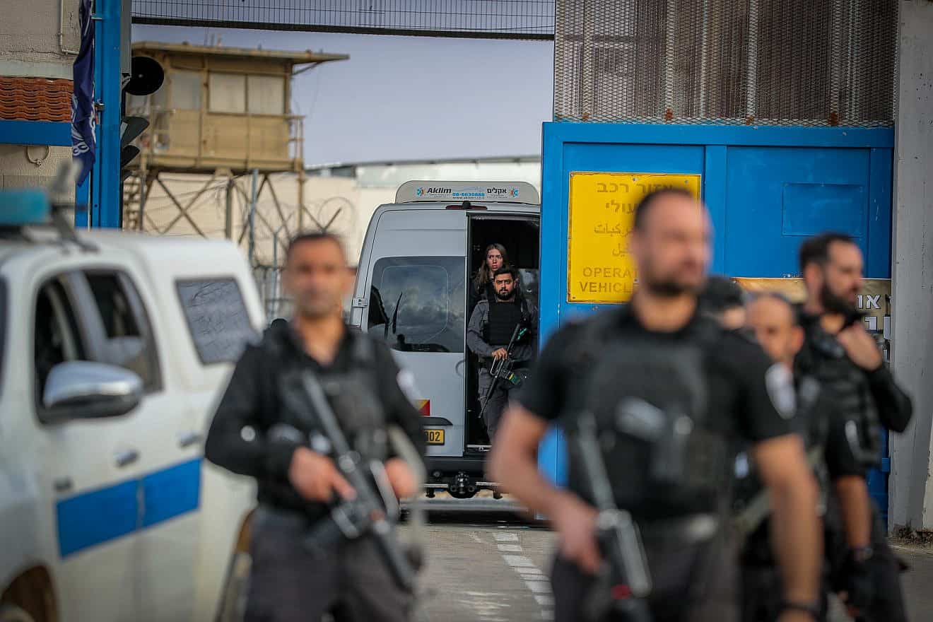 Guards escort Palestinian terrorists arriving at Ofer Prison, southwest of Ramallah, being released as part of a deal between Israel and Hamas, Nov. 25, 2023. Photo by Jamal Awad/Flash90.