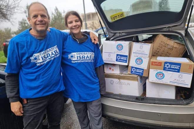 Volunteers transport gear after it arrives in the Jewish state. Credit: Courtesy of Operation Israel.