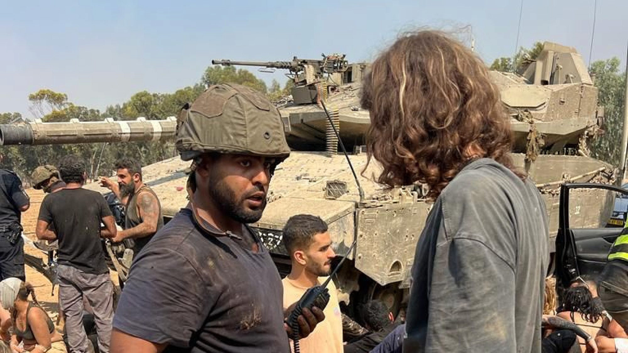 Daniel Sharabi (wearing helmet) and other Israelis regroup and treat the wounded after fleeing Hamas's attack on the Supernova Music Festival at Kibbutz Re'im on Oct. 7, 2023. Credit: Courtesy.
