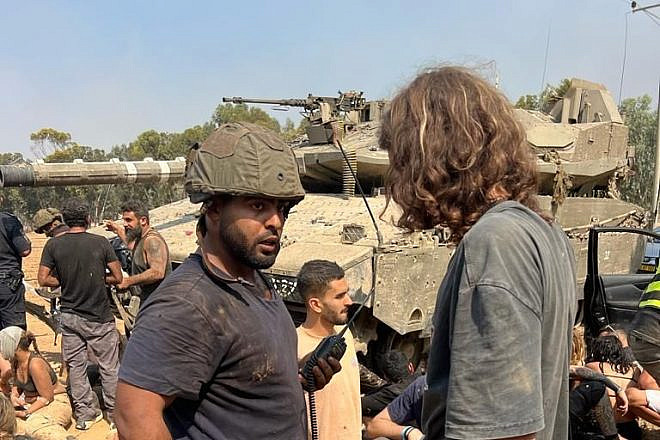 Daniel Sharabi (wearing helmet) and other Israelis regroup and treat the wounded after fleeing Hamas's attack on the Supernova Music Festival at Kibbutz Re'im on Oct. 7, 2023. Credit: Courtesy.