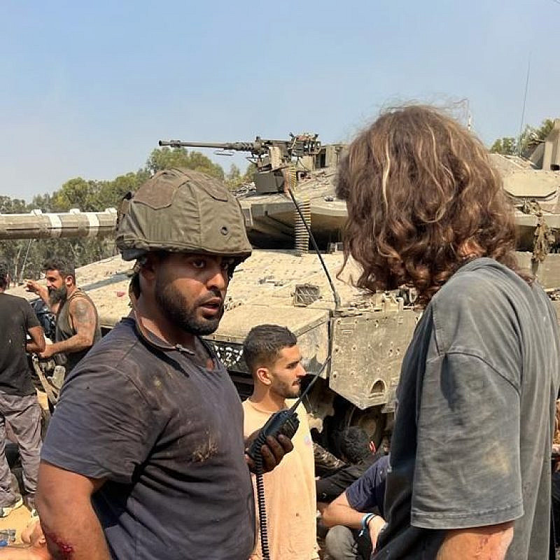 Daniel Sharabi (wearing helmet) and other Israelis regroup and treat the wounded after fleeing Hamas's attack on the Supernova Music Festival at Kibbutz Re'im on Oct. 7, 2023. Credit: Courtesy.