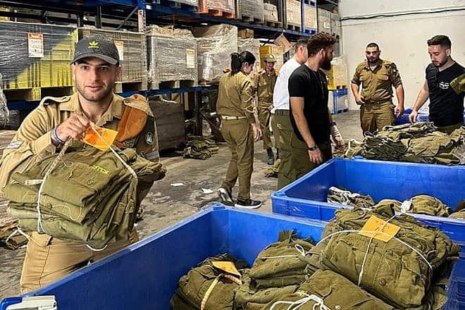 IDF soldiers with special needs pack equipment at a logistics center in Ramle. Credit: Special in Uniform.