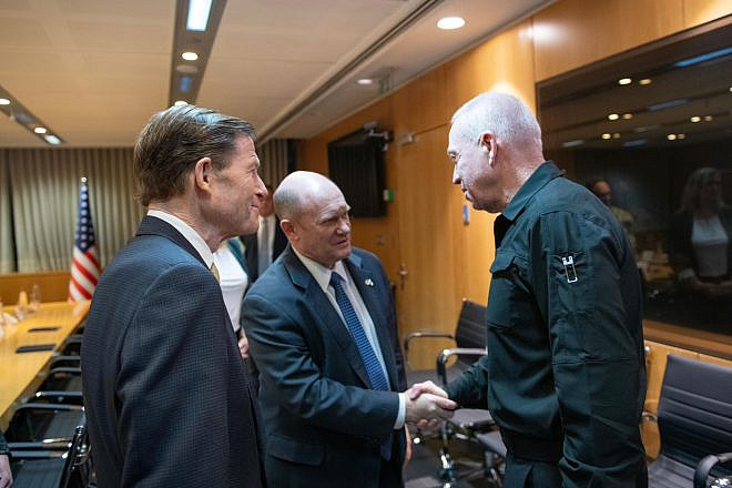 Israeli Defense Minister Yoav Gallant (right) shakes hands with Sen. Chris Coons (D-Del.), as Sen. Richard Blumenthal (D-Conn.) looks on during a Feb. 18, 2024 meeting in Tel Aviv. Credit: Shachar Yurman/Israeli Ministry of Defense.