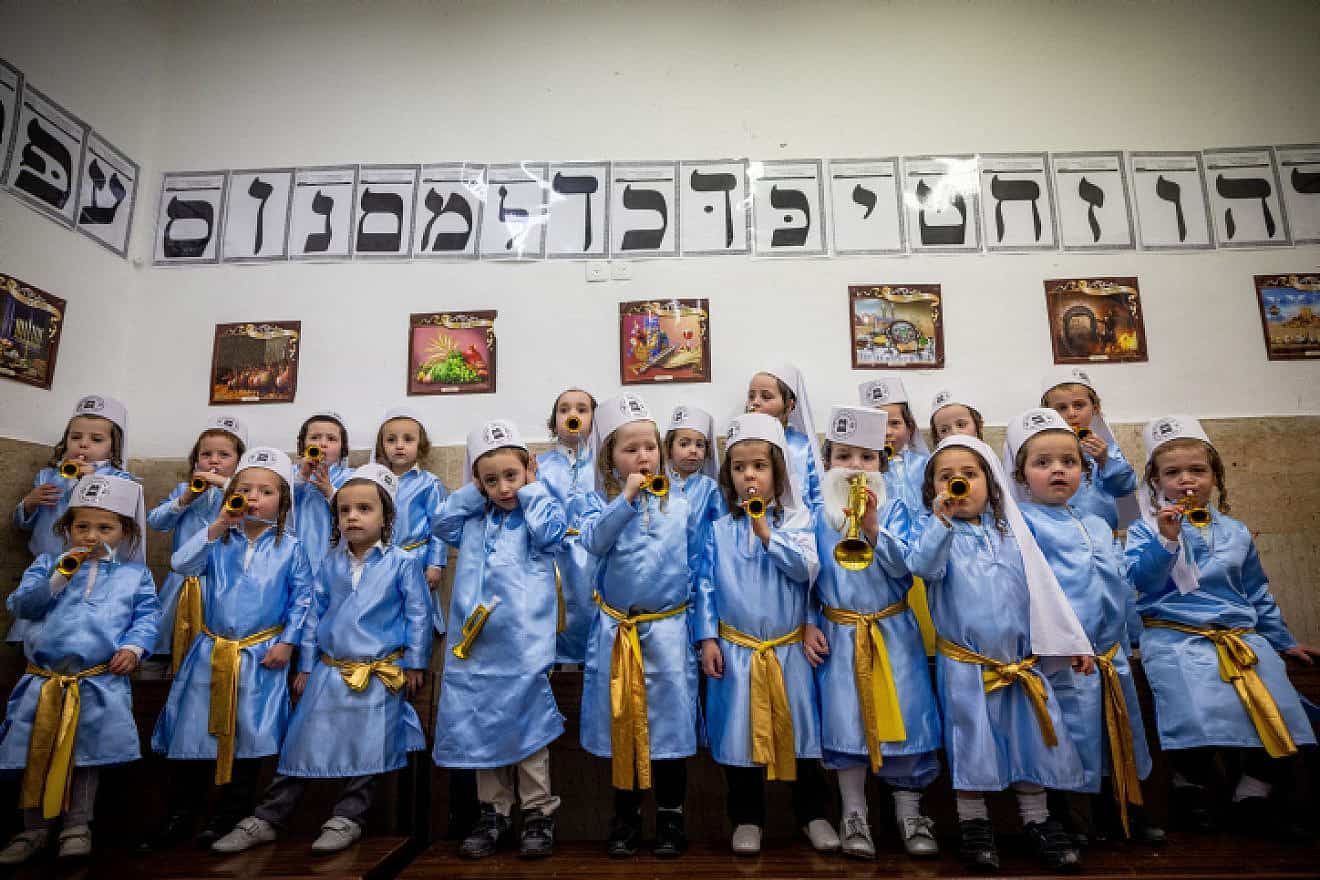 Jewish children from Pinsk-Karlin Chassidic group dressed up in costumes at their school in Jerusalem's ultra-Orthodox Mea Shearim neighborhood a few days before Purim, March 5, 2022. Photo by Yonatan Sindel/Flash90.
