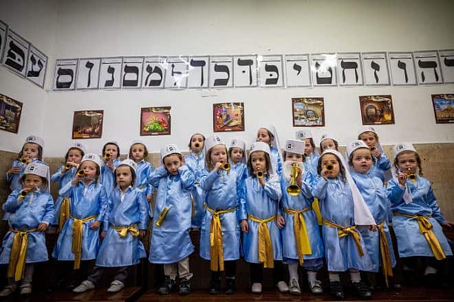 Jewish children from Pinsk-Karlin Chassidic group dressed up in costumes at their school in Jerusalem's ultra-Orthodox Mea Shearim neighborhood a few days before Purim, March 5, 2022. Photo by Yonatan Sindel/Flash90.
