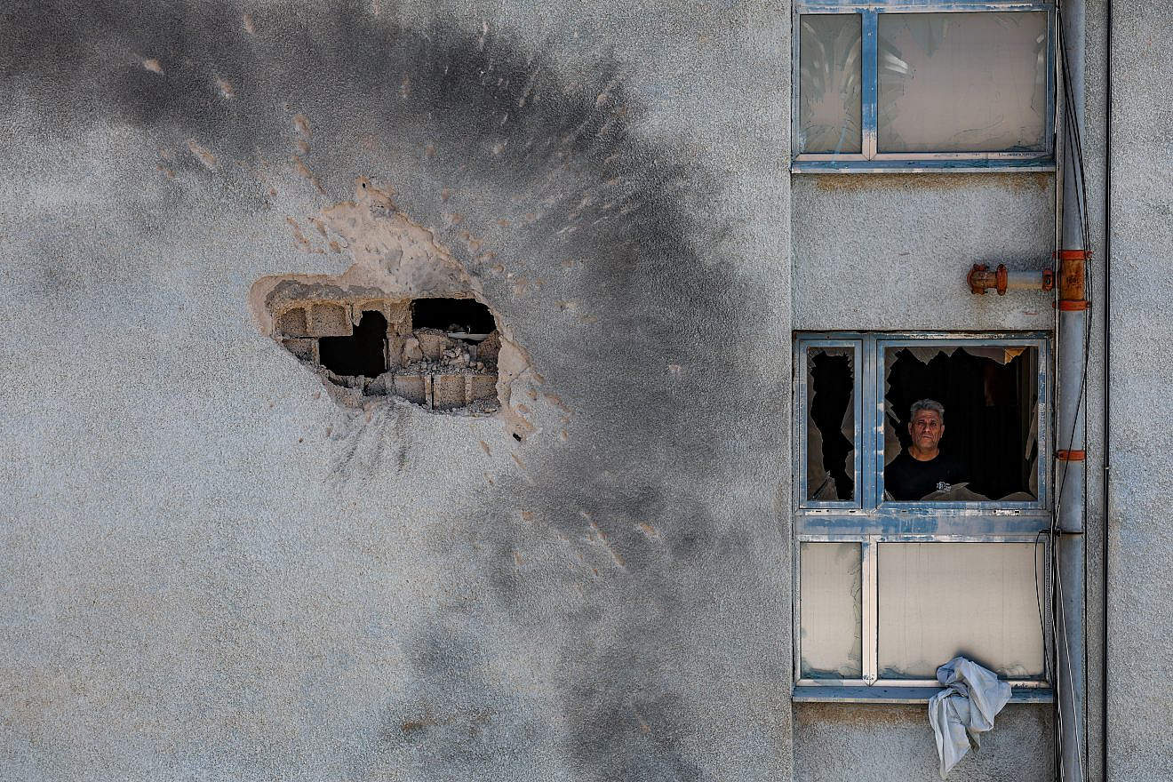 Damage after a rocket fired by Hezbollah in Lebanon hit a building in the northern Israeli town of Kiryat Shmona, Feb. 11, 2024. Photo by David Cohen/Flash90.