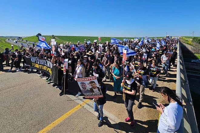 Supporters of Israelis held by Hamas in Gaza begin the second day of their four-day cross-country march at Kibbutz Gat, Feb. 29, 2024. Credit: The Hostage and Missing Families Forum.