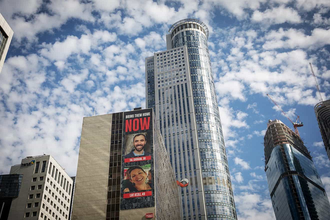 Photos of civilians who have been held hostage by Hamas terrorists in the Gaza Strip since Oct. 7, displayed on a building in Ramat Gan, Jan. 21, 2024. Photo by Miriam Alster/Flash90.