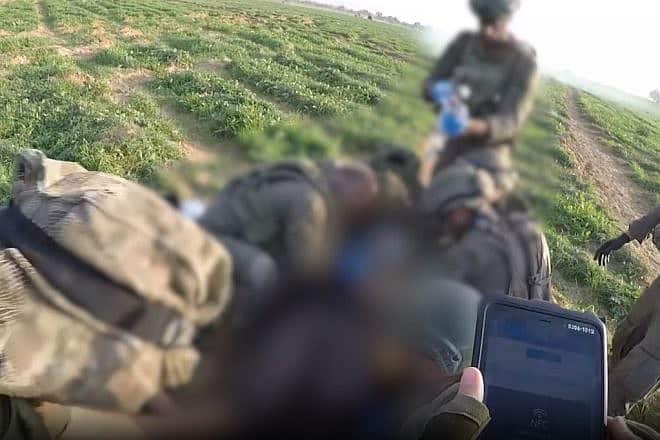 Israeli troops treat a wounded comrade in the Gaza Strip as one of the soldiers enters details into an app. Source: Screenshot via IDF Spokesperson.