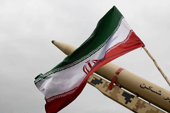 An Iranian flag over a missile, April 2022. Credit: Mohasseyn/Shutterstock.