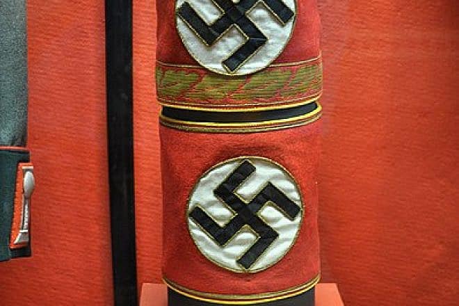 Armband of the German Nazi Party, worn around the upper left sleeve of the uniform tunic and bearing a swastika. Credit: Joe Mabel via Wikimedia Commons.