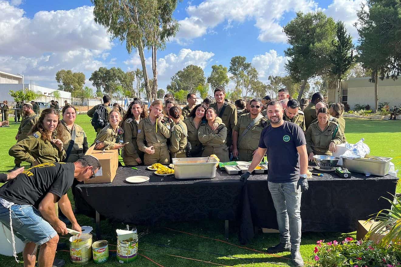 Shimon Biton feeds IDF soldiers at an army base. Credit: Courtesy,