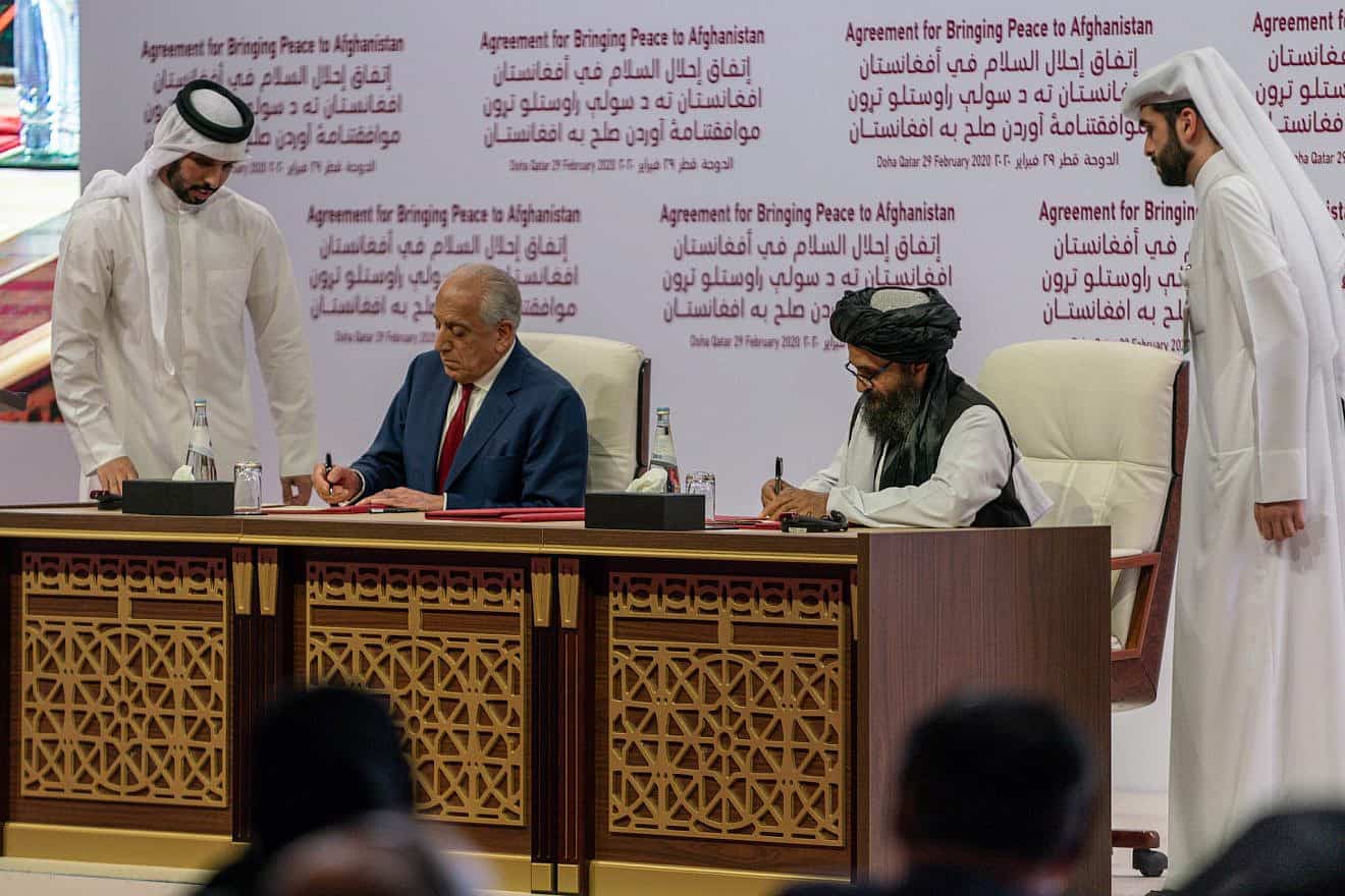 Zalmay Khalilzad, U.S. Special Representative for Afghanistan Reconciliation (left), and Taliban representative Abdul Ghani Baradar (right) sign the agreement to bring peace to Afghanistan in Doha, Qatar on Feb. 29, 2020. Credit: U.S. Department of State via Wikimedia Commons.