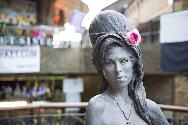 A bronze statue of Amy Winehouse in Camden Town in London. Credit: Nando Machado/Shutterstock.