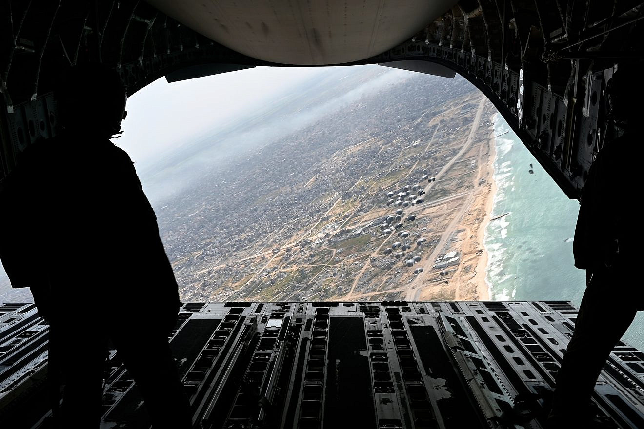 U.S. Air Force loadmasters watch as humanitarian aid for Gaza is airdropped from an Air Mobility Command C-17  Globemaster III from an undisclosed location in the U.S. Central Command area of responsibility on March 21st, 2024. Credit: Staff Sgt. Christian Sullivan/U.S. Air Force Photo.