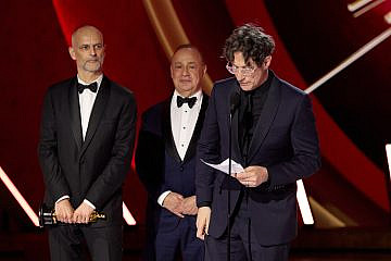 From left: James Wilson, Leonard Blavatnik and Jonathan Glazer accept the Oscar for Best International Feature Film “The Zone of Interest” during the live “ABC” telecast of the 96th Oscars at the Dolby Theatre at Ovation Hollywood on March 10, 2024. Credit: Academy of Motion Picture Arts & Sciences.