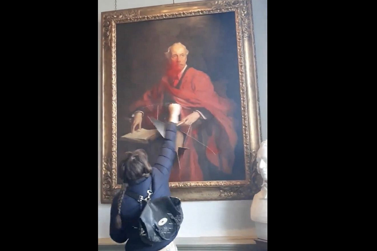 Screen capture of widely-circulating video footage of an anti-Israel activist slashing a 1914 painting of Arthur Balfour, of Balfour Declaration fame, at Trinity College, part of the University of Cambridge in England.