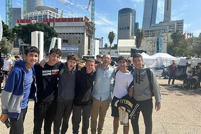 Librarian Kobi Abarbanel with students from Jerusalem's Hartman High School, including Chai Lascar (second from right), in Tel Aviv's "Hostage Square," March 21, 2024. Photo by Amelie Botbol.