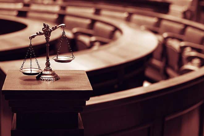 Symbol of law and justice in a courtroom. Credit: corgarashu/Shutterstock.