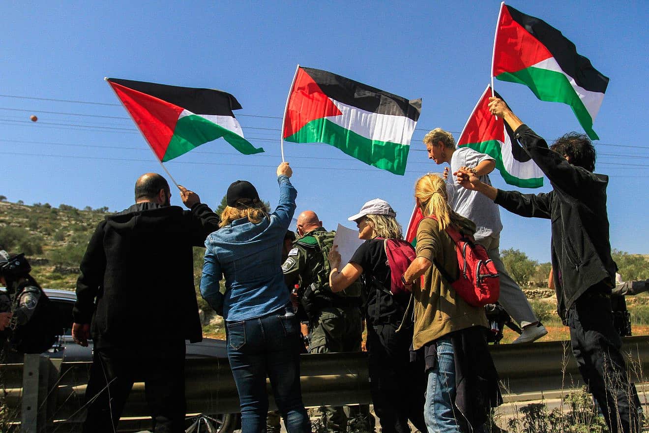 Left-wing protesters hold PLO flags in Huwara, near Nablus in Samaria, March 3, 2023. Photo by Nasser Ishtayeh/Flash90.
