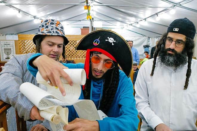 Jews read the Esther Scroll on the eve of the Jewish holiday of Purim at a synagogue in Katzrin, northern Israel, March 6, 2023. Photo by Michael Giladi/Flash90.