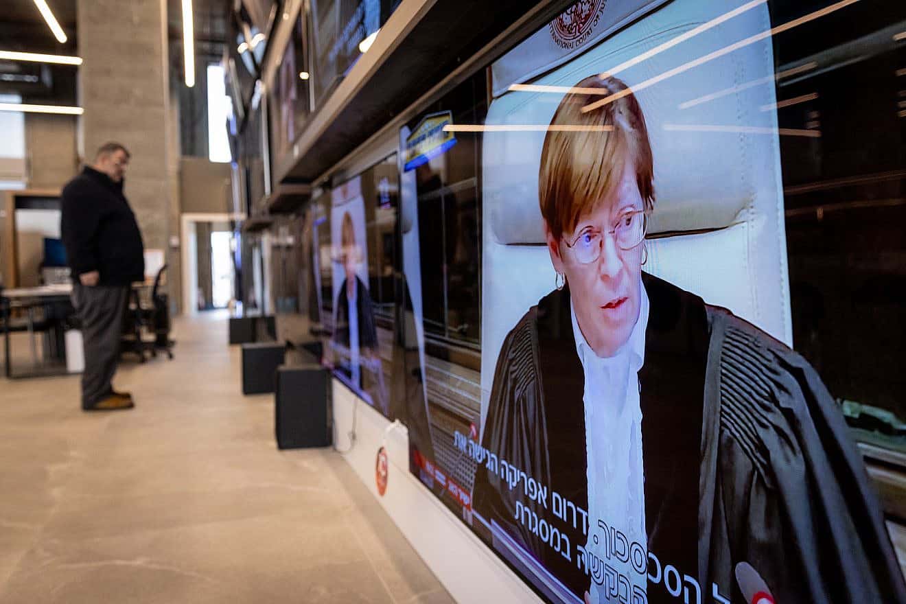 Jerusalemites watch a hearing at the International Court of Justice in The Hague, regarding the lawsuit initiated by South Africa accusing Israel of genocide, Jan. 26, 2024. Photo by Chaim Goldberg/Flash90.