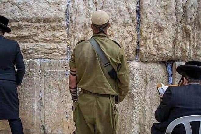 Jews pray at the Western Wall in Jerusalem. Photo by Oren Ben Hakoon.
