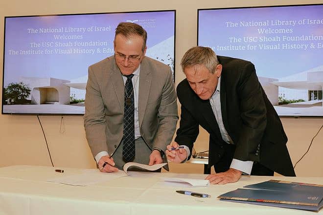 Robert J. Williams, executive director of the USC Shoah Foundation (left) and Sallai Meridor, chairman of the National Library of Israel, sign the Memorandum of Understanding in Jerusalem between the two partnered organizations, March 4, 2024. Photo by Menachem Schloss.