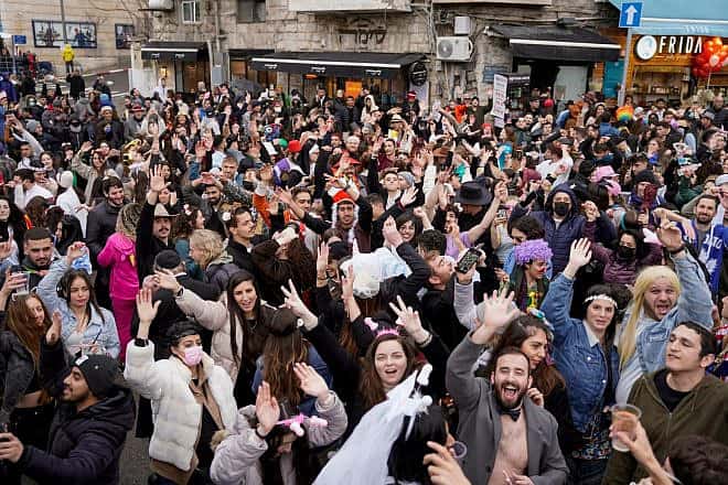 People party during Purim on Agrippas Street, near Jerusalem's Machane Yehuda market. Courtesy of the Jerusalem Municipality.