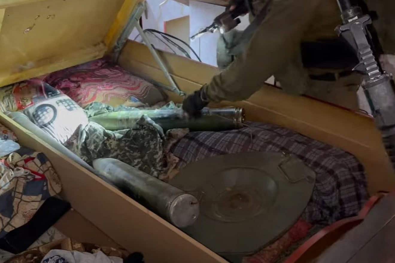 Israeli soldiers find missiles and explosives under a bed in a bedroom in Khan Yunis, Gaza, March 13, 2024. Source: YouTube screenshot/IDF.