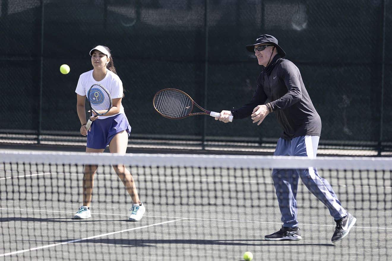 Inbar Poni from Ramat Hasharon, Israel, plays alongside legendary tennis coach Brad Gilbert at St. Andrews Country Club in Boca Raton, Fla. Credit: Courtesy of the Israel Tennis and Education Centers.