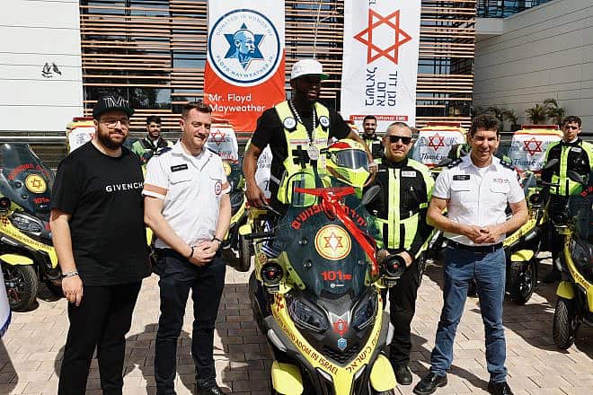 Floyd Mayweather Jr. with one of the ambucycles during a visit to Magen David Adom's Marcus National Blood Services Center in Ramle on March 13, 2024. Credit: MDA.