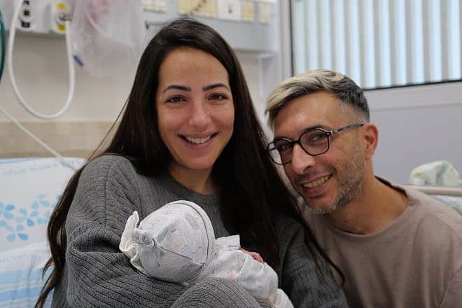 Supernova music festival survivors Astar Moshe, 35, and Shlomi Tobi, 37, with their newborn baby in April 2024. Credit: Rambam Medical Center.
