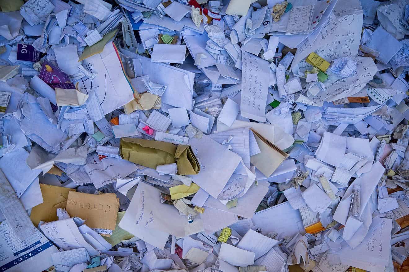 Notes that were removed after being placed between the stones of the Western Wall in the Old City of Jerusalem, Sept. 24, 2019.  Credit: Yonatan Sindel/Flash90.