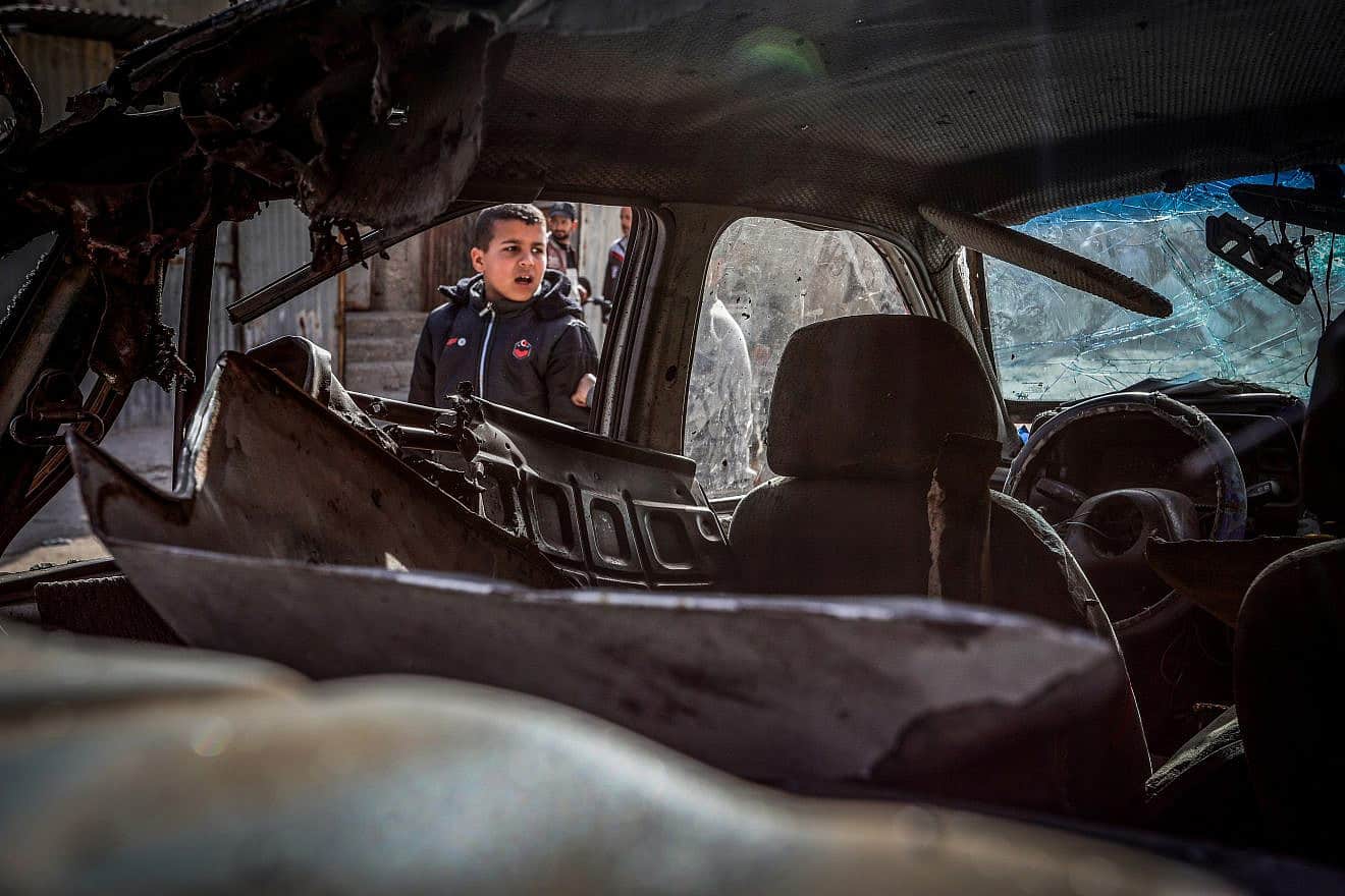 Palestinians outside a car after it was hit by an Israeli airstrike in Rafah, in the southern Gaza Strip, March 2, 2024. Photo by Abed Rahim Khatib/Flash90.