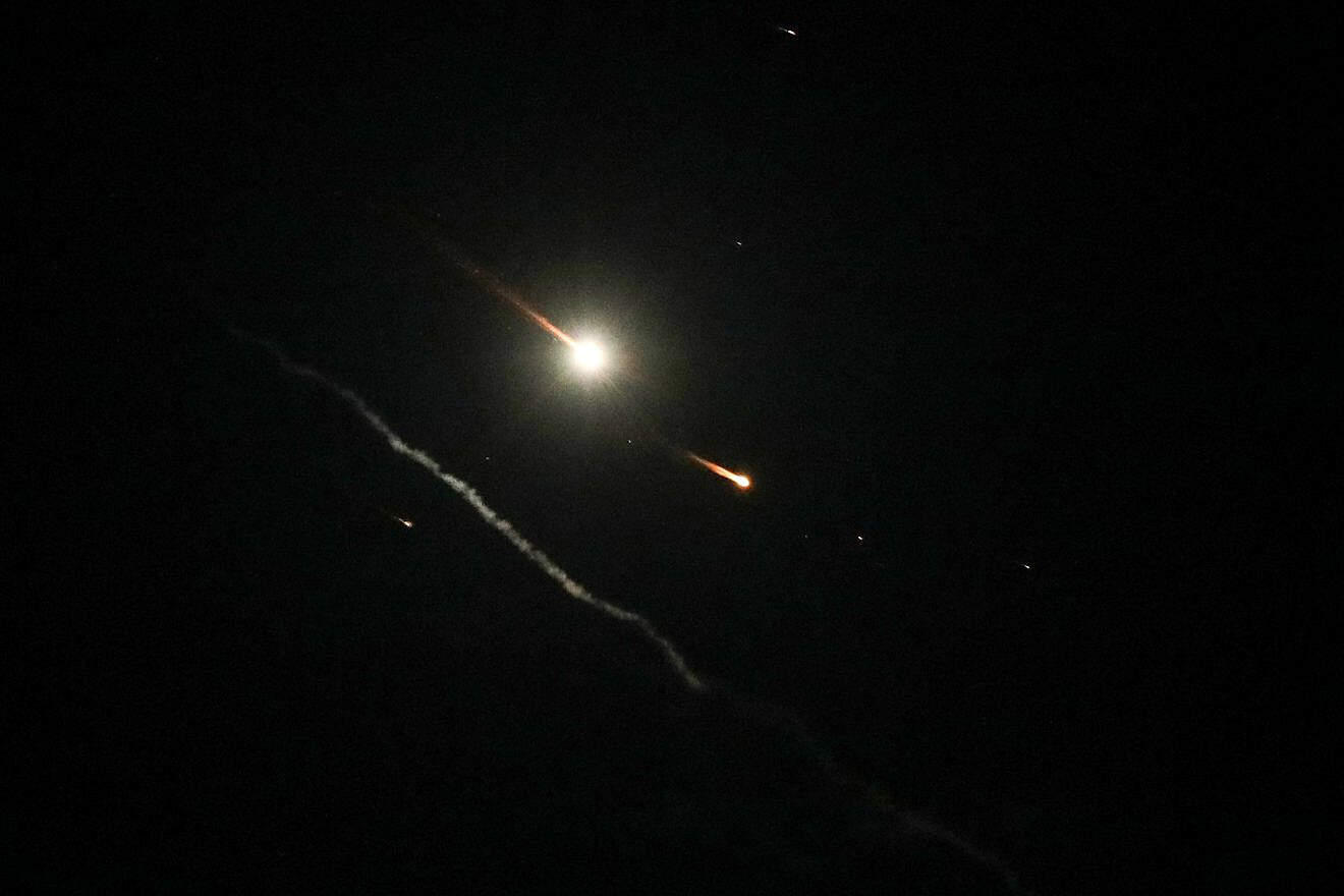 An Israeli anti-missile system fires interceptors at drones, rockets and missiles launched by Iran, as seen over the city of Hebron on April 14, 2024. Photo by Wisam Hashlamoun/Flash90.