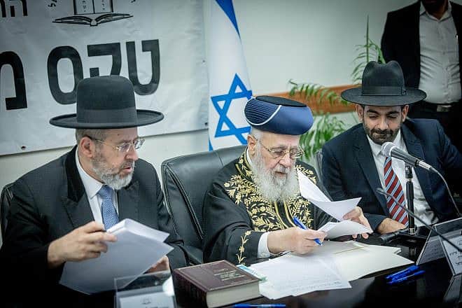 Israel's Chief Rabbis David Lau (left) and Yitzhak Yosef (center) sell the state's chametz in Jerusalem ahead of Passover, April 21, 2024. They left their posts on June 30. Photo by Chaim Goldberg/Flash90.