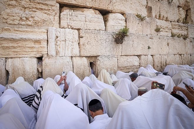 Jewish worshippers pray in front of the Western Wall in Jerusalem's Old City during the Kohen Benediction, the priestly blessing at the Jewish holiday of Passover, which commemorates the Israelites' hasty departure from Egypt, April 25, 2024. Photo by Chaim Goldbergl/Flash90.