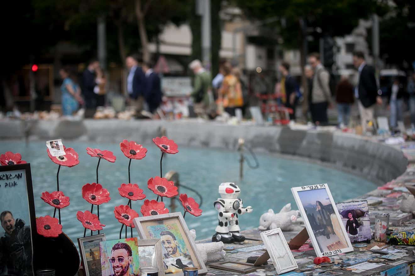 Israelis walk past candles and photos of the victims killed and held hostage by Hamas terrorists in Gaza since the Oct. 7 massacre, on Dizengoff Square in Tel Aviv on April 8, 2024. Photo by Miriam Alster/Flash90.