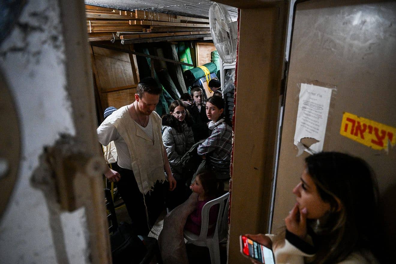 Israelis take cover in a safe room in Jerusalem after a Red Alert siren sounds as a barrage of missiles, rockets and drones are launched by Iran towards the Jewish state on April 14, 2024. Photo by Arie Leib Abrams/Flash90.