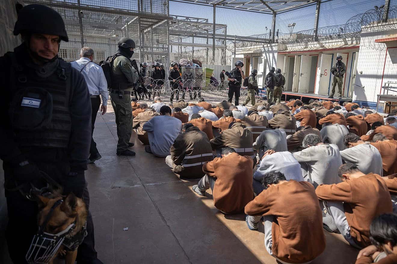 Israel Prison Service personnel stand guard over Hamas terrorists caught during the Oct. 7 massacre and IDF operations in the Gaza Strip, at a prison in southern Israel, Feb. 14, 2024. Photo by Chaim Goldberg/Flash90.
