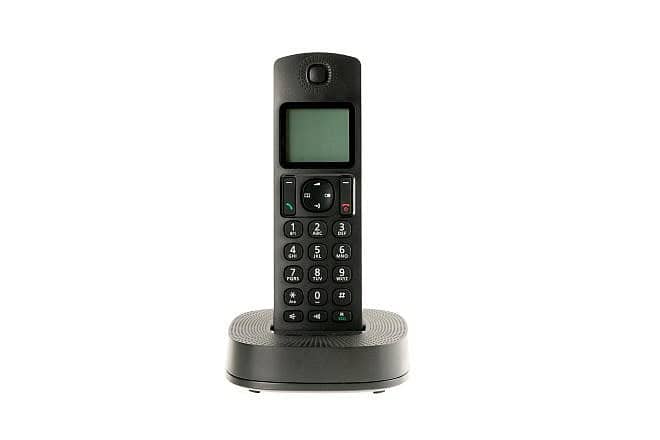 A cordless phone with a charging station that connects to a landline. Credit: 2ban/Shutterstock.
