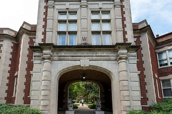 Missouri School of Journalism archway, on the Columbia, Mo. campus of the University of Missouri, with two Chinese stone sculptures and the inscription "Wise shall be the bearers of light." Credit: APN Photography/Shutterstock.