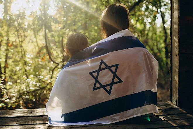 An image of sisters draped in the Israeli flag. Source: Pazargic Liviu/Shutterstock