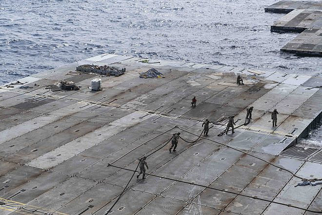 U.S. Army soldiers assigned to the 7th Transportation Brigade (Expeditionary) handle line to secure the roll-on, roll-off distribution facility—or floating pier—to the side of the MV Roy P. Benavidez, in support of operations off the coast of Gaza on May 1, 2024. Credit: U.S. Navy Photo.