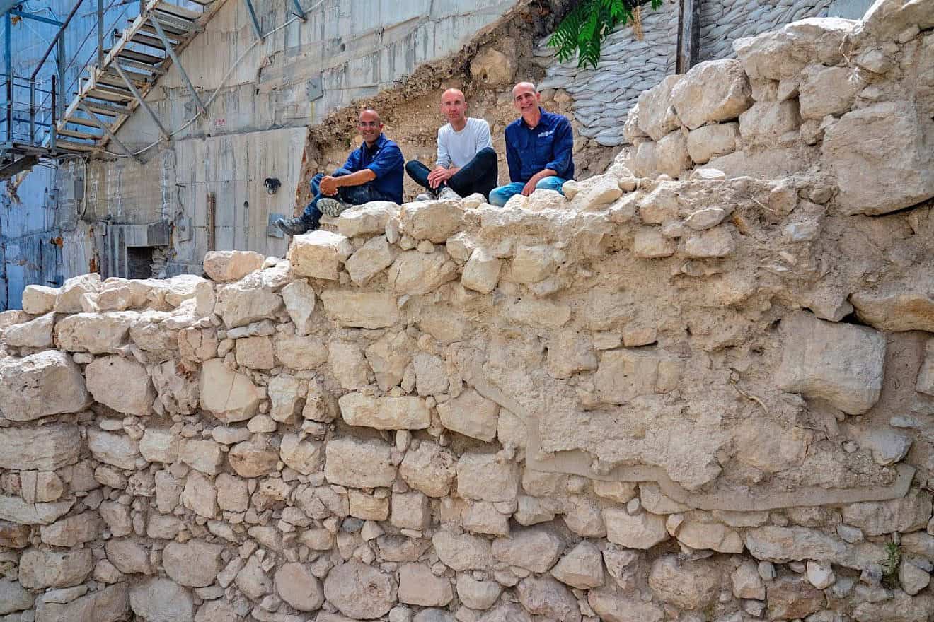 The wall of Jerusalem as uncovered in the excavations of the Israel Antiquities Authority, with, from left, Ortal Chalaf, Dr. Filip Vukosavovich and Dr. Joe Uziel. Photo by Kobi Harati/City of David Foundation.