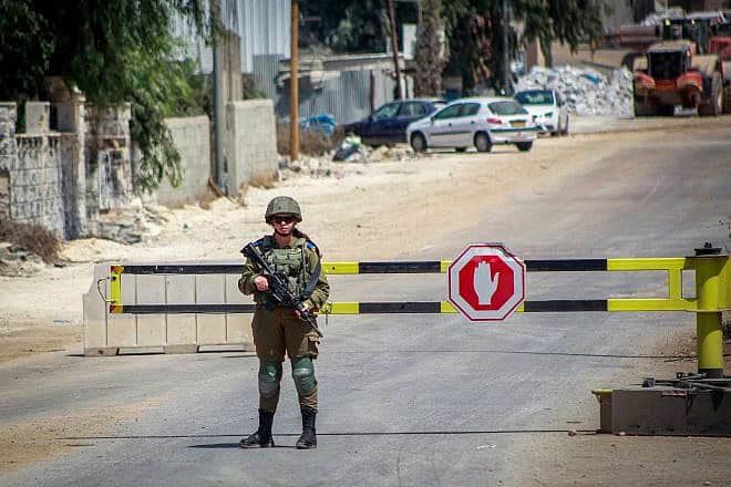 Israeli soldiers block the entrance to the village of Beita in northern Samaria during searches for the terrorist who carried out an attack in Huwara, on Aug. 20, 2023. Photo by Nasser Ishtayeh/Flash90.